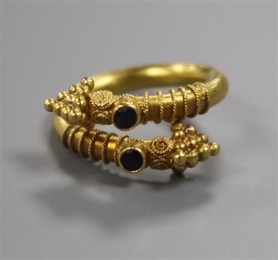 A yellow metal and gem set Etruscan style ring, size I.